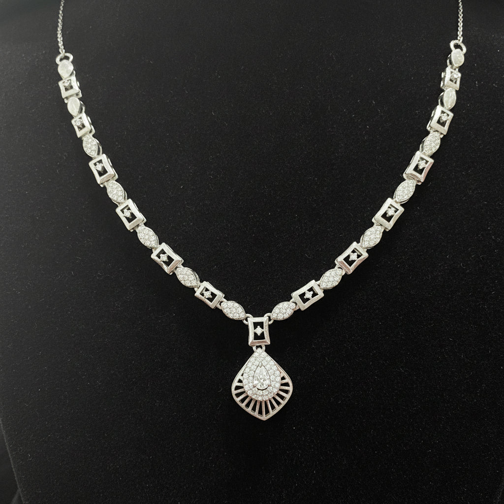 Silver necklace with a diamond pendant on a red velvet background