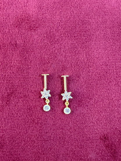 92.5 silver Pair of gold and silver floral earrings on a purple fabric background