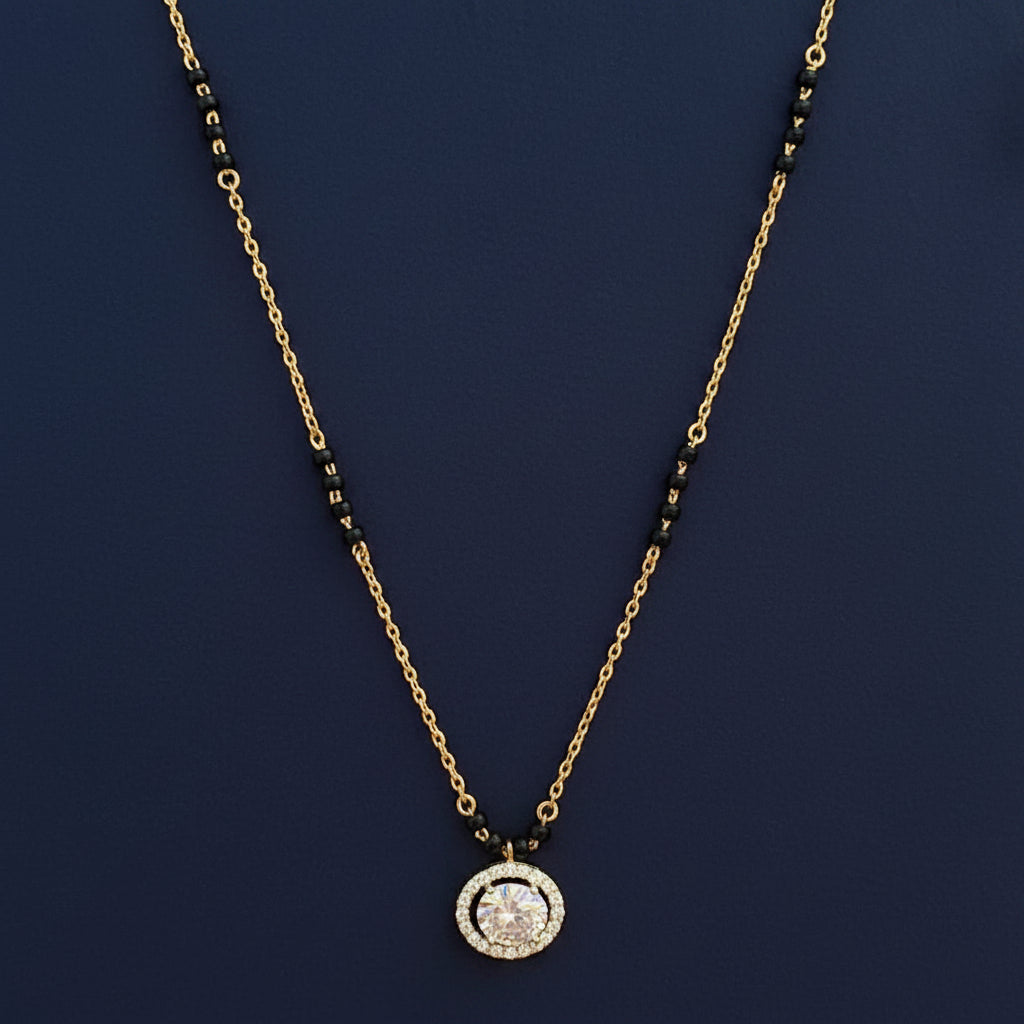 Gold necklace with a pendant on a red fabric background
