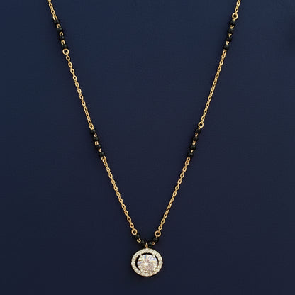 Gold necklace with a pendant on a red fabric background