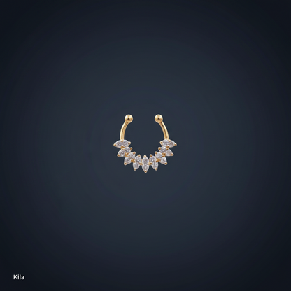 Gold and diamond earring on a person's earlobe with a blue background