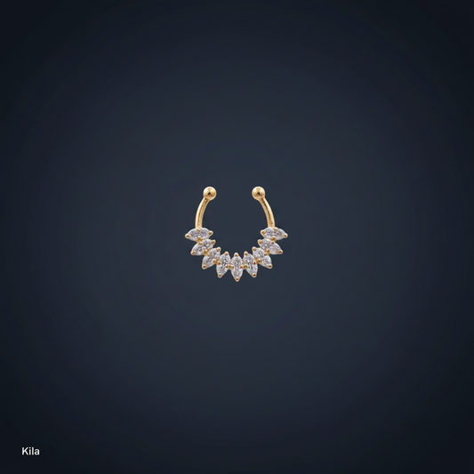 Gold and diamond earring on a person's earlobe with a blue background