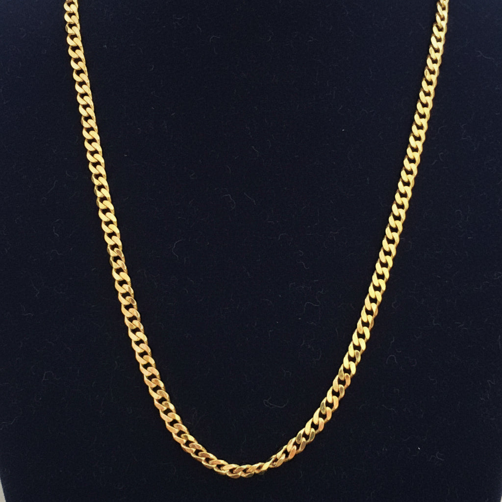 Gold chain on a red fabric background