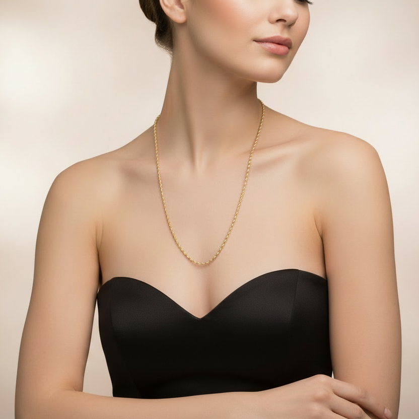 Woman wearing a gold necklace and white dress against a beige background