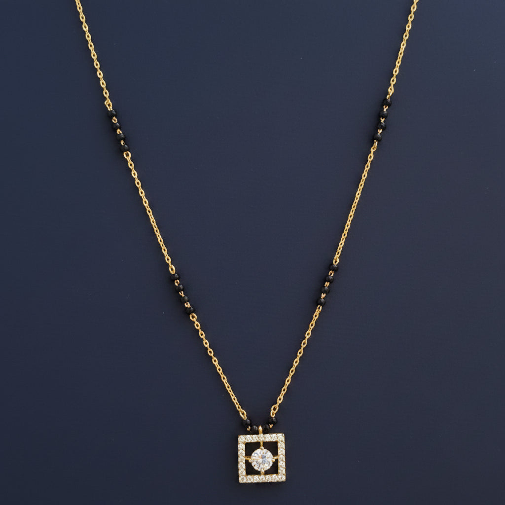 Gold necklace with a decorative pendant on a red fabric background