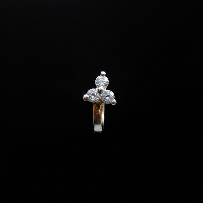 Gold ring with a diamond on a finger against a blue background