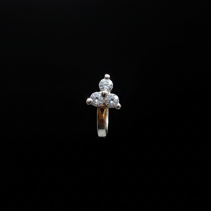 Gold ring with a diamond on a finger against a blue background