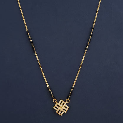 Gold and black necklace on a red fabric background