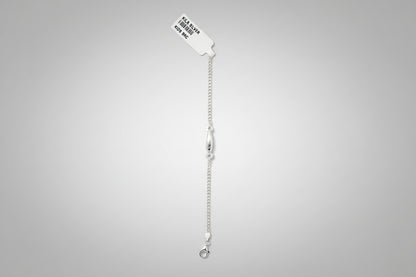 Silver bracelet on a teal fabric background