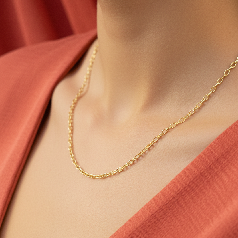 Gold necklace worn by a person with a red garment