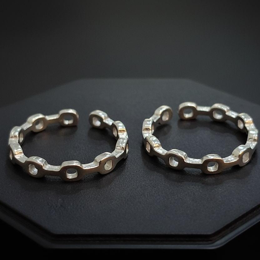 Gold hoop earrings on a black stand with a pink background