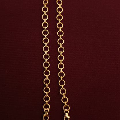 Gold chain with a tag on a red textured background