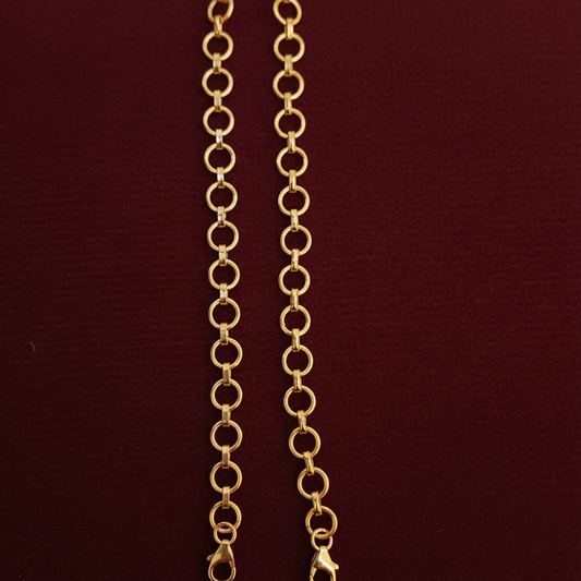 Gold chain with a tag on a red textured background