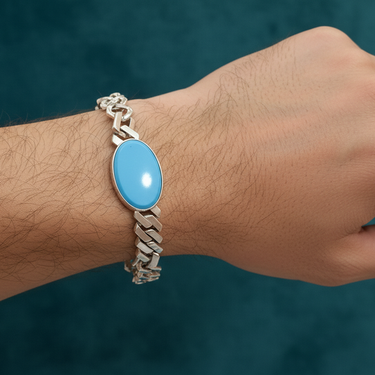 Bracelet with a blue stone on a wrist against a dark background