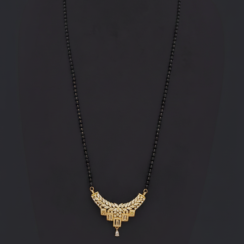 Gold necklace on a mannequin with a red background