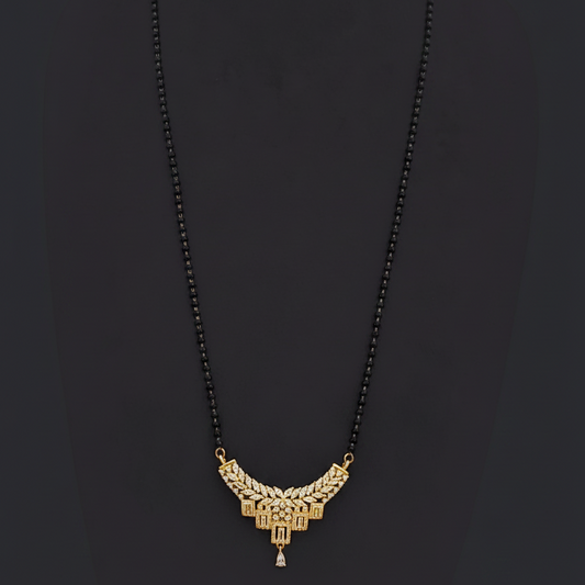 Gold necklace on a mannequin with a red background