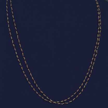 Close-up of a red fabric surface with gold stitching