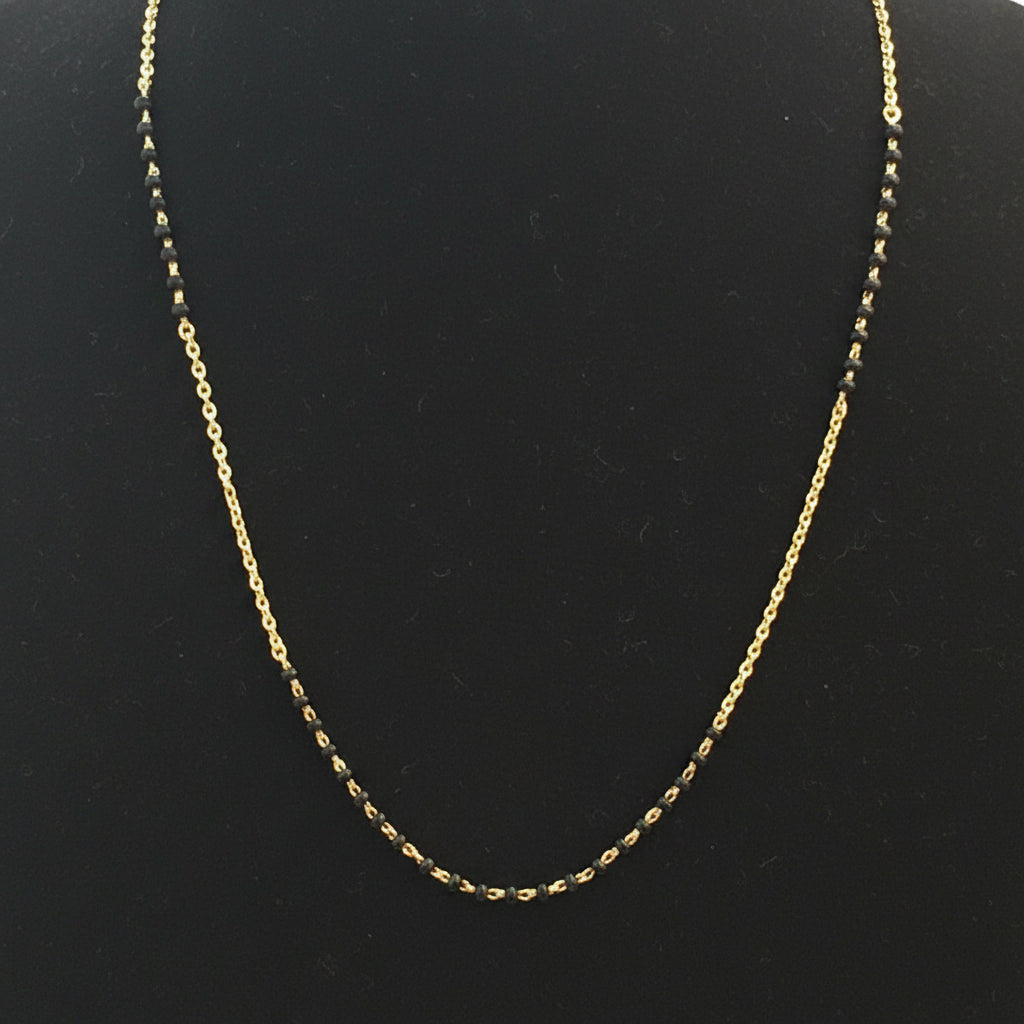 Gold chain on a red fabric surface