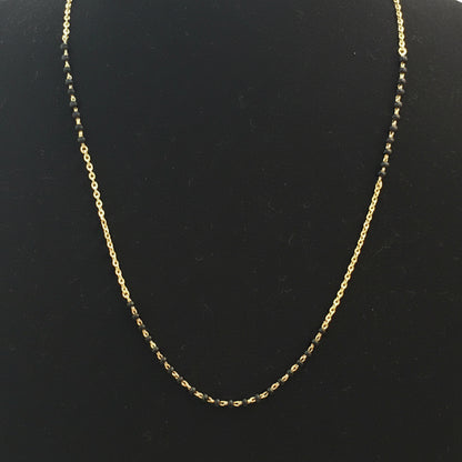 Gold chain on a red fabric surface