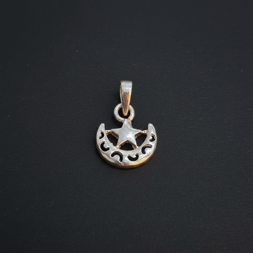 Silver charm with star design on a red fabric background, accompanied by a Kila Silver label.