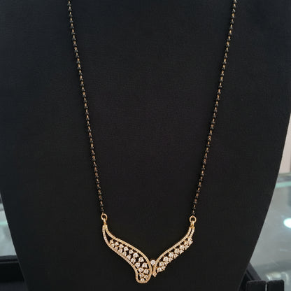 Gold necklace on a red cushion with a blurred background