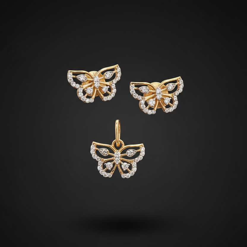 Gold butterfly earrings with diamond accents held between fingers against a red fabric background