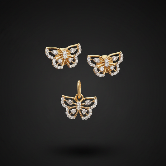 Gold butterfly earrings with diamond accents held between fingers against a red fabric background