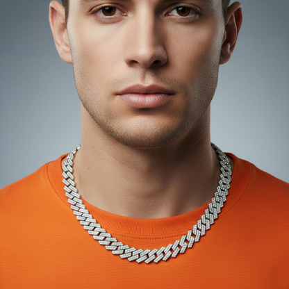 Man wearing a silver chain necklace against a gray background