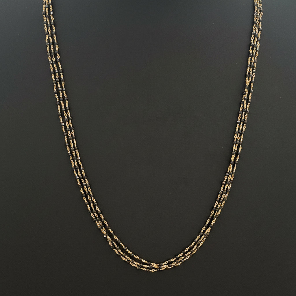 Gold chain on a red fabric surface