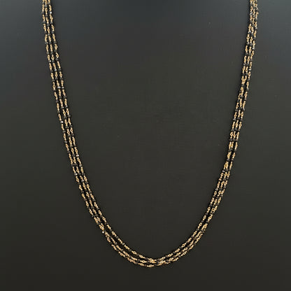 Gold chain on a red fabric surface
