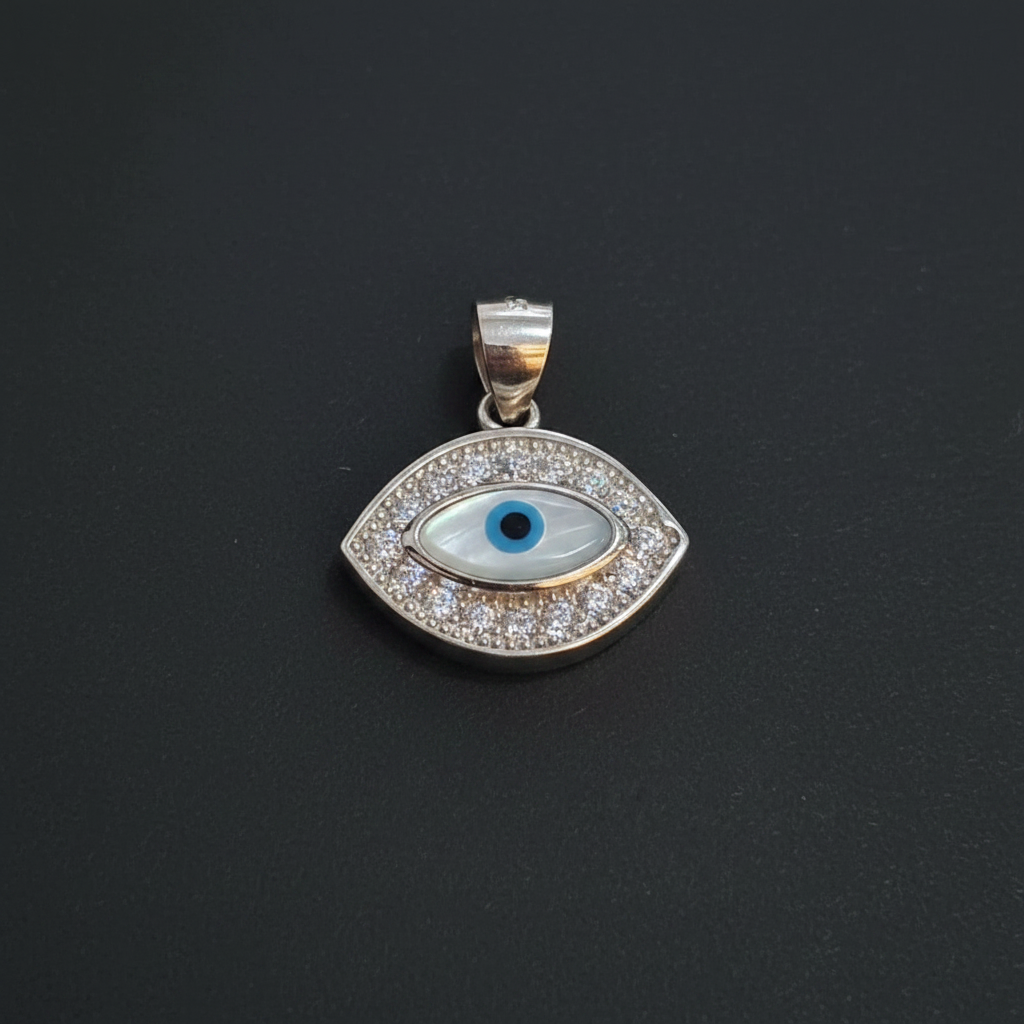 Silver pendant with blue gemstone on a maroon background, next to a ruler and Kila Silver tag.