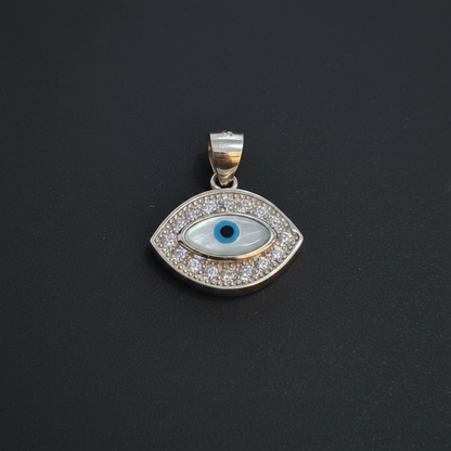 Silver pendant with blue gemstone on a maroon background, next to a ruler and Kila Silver tag.