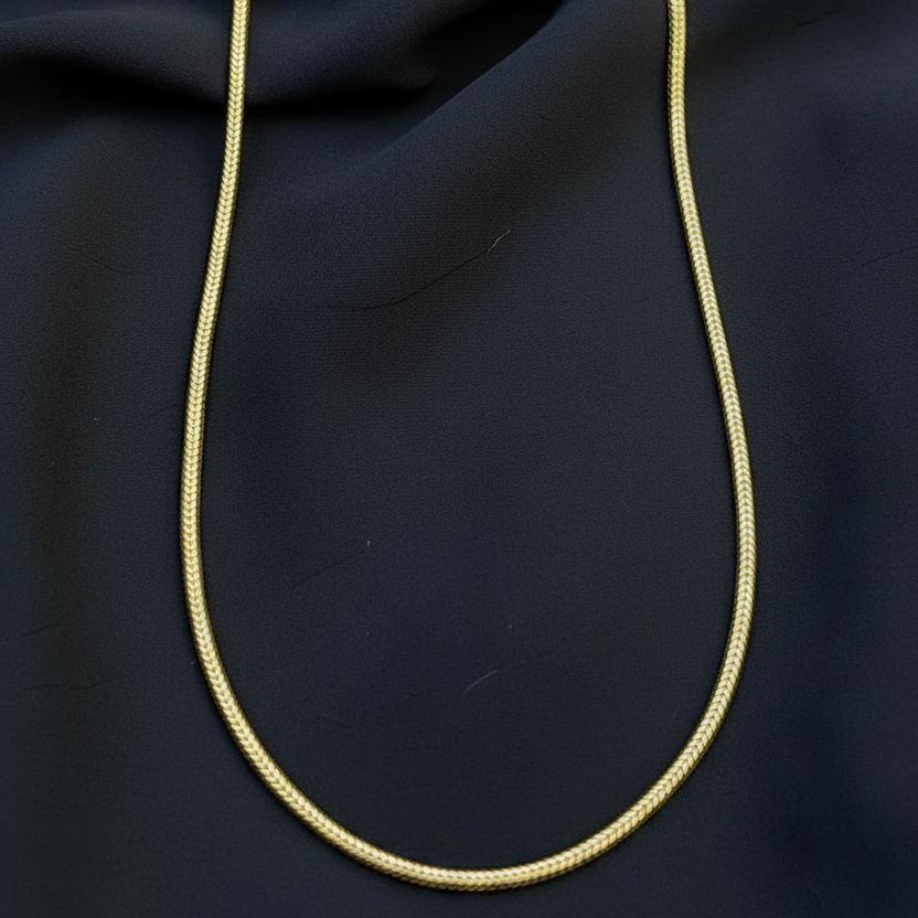 Red fabric with a gold cord on a red background