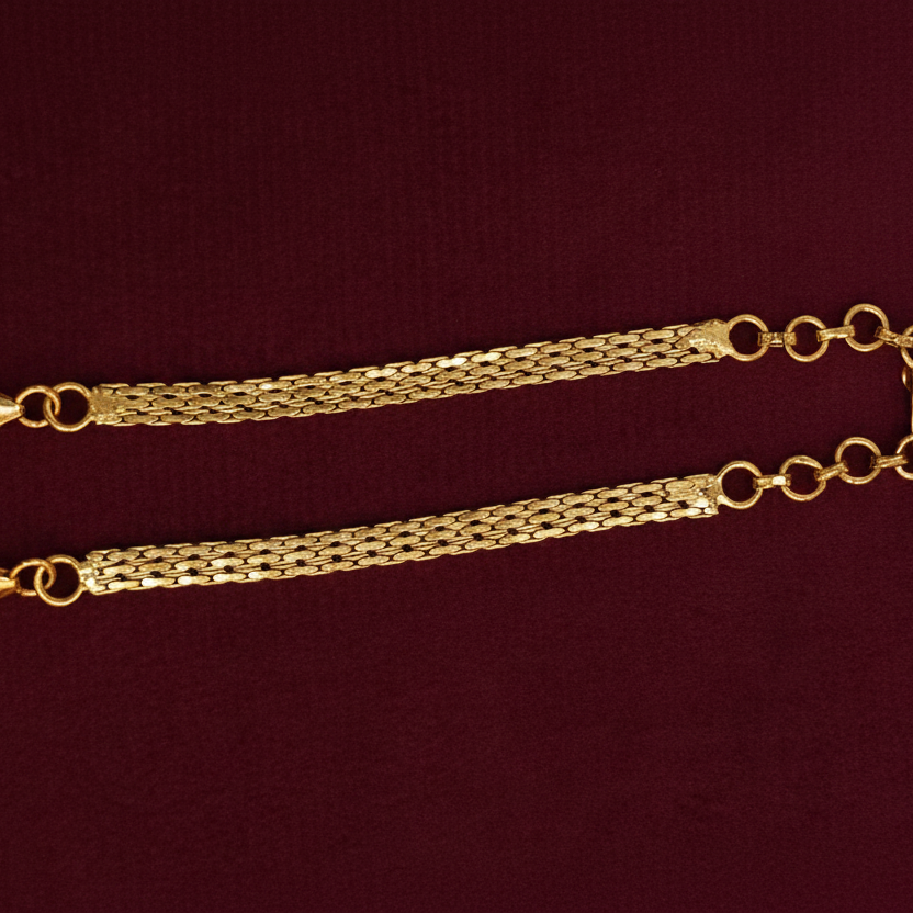 Gold chain with a tag on a red background