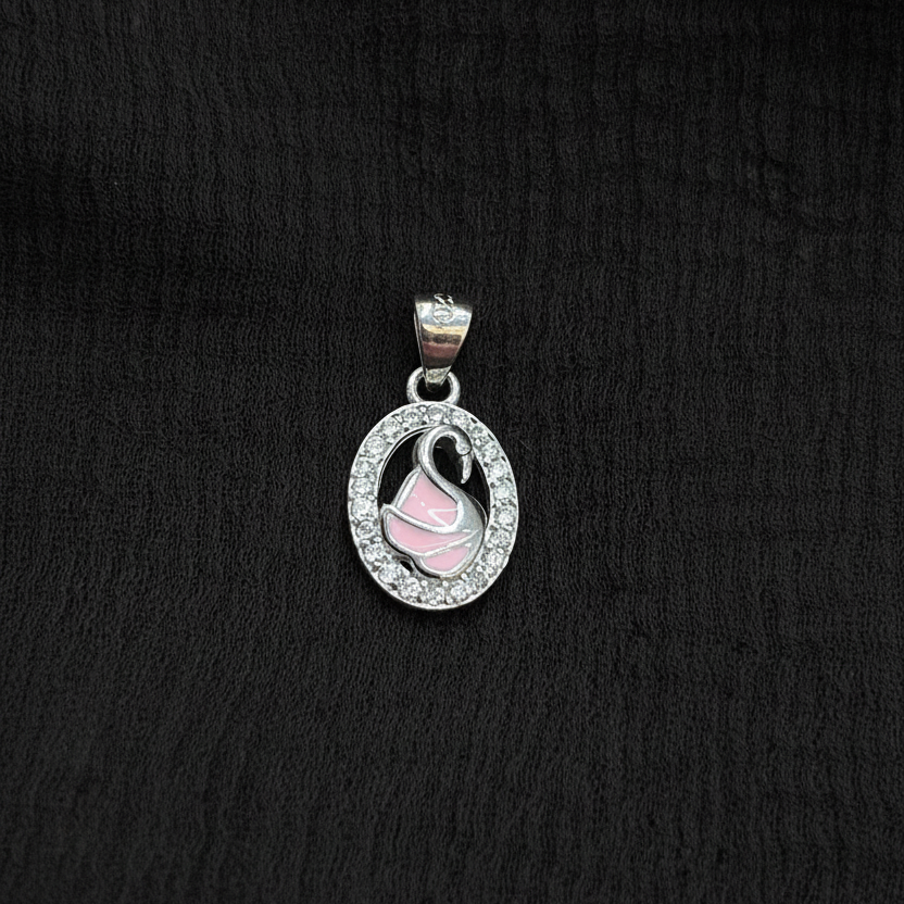 Silver charm with pink heart on a red fabric background
