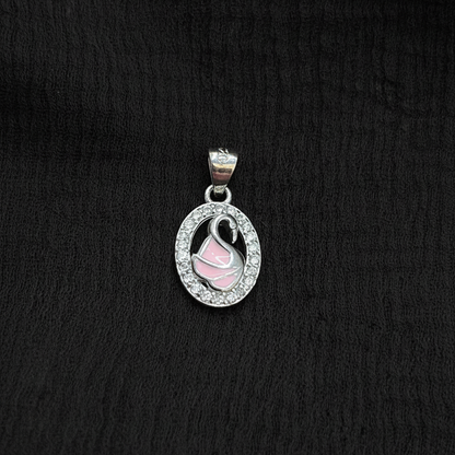 Silver charm with pink heart on a red fabric background