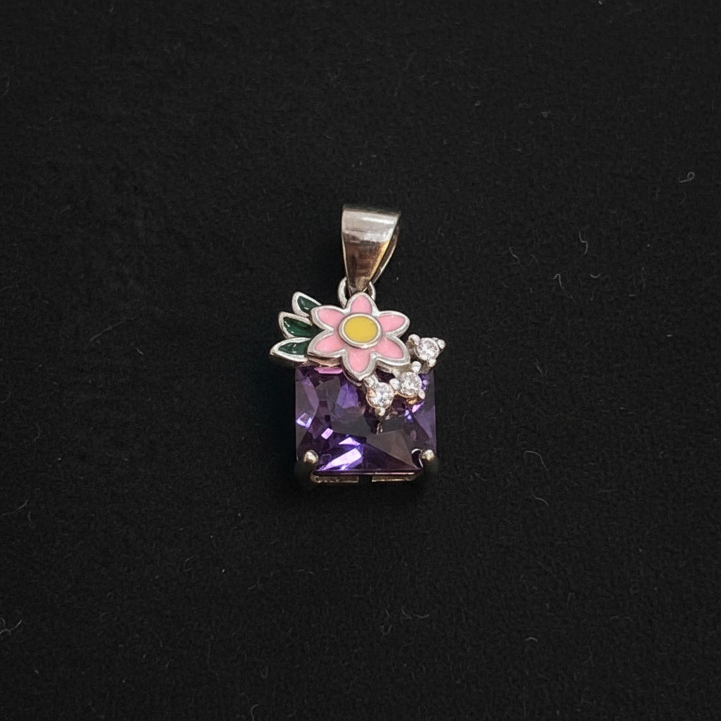 Small decorative item with a purple gemstone on a red background, accompanied by a ruler for scale.