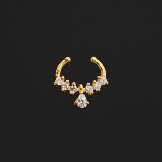Gold nose ring with small diamonds on a teal textured background