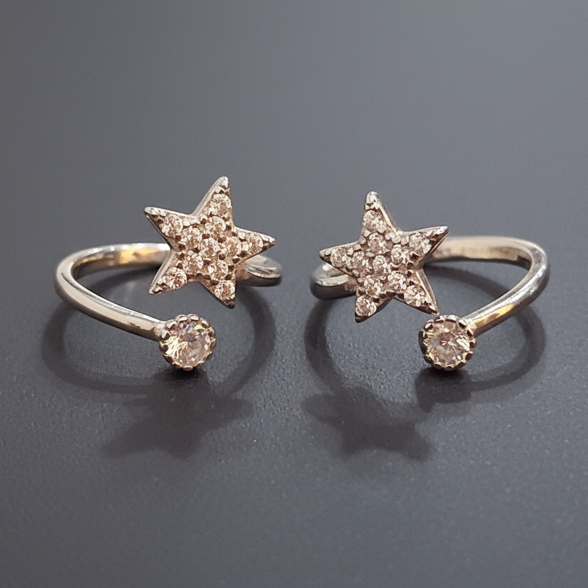 Two gold star-shaped rings on a black stand with a pink background