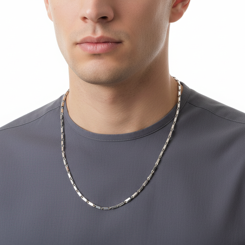 Man wearing a silver chain necklace on a white background