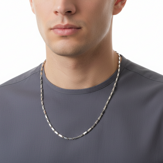 Man wearing a silver chain necklace on a white background