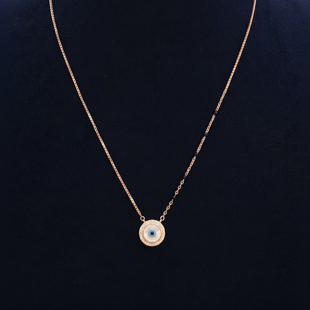 Gold necklace with a blue gemstone pendant on a red fabric background