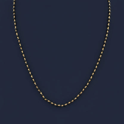 Close-up of a red garment with a chain detail on a blurred background