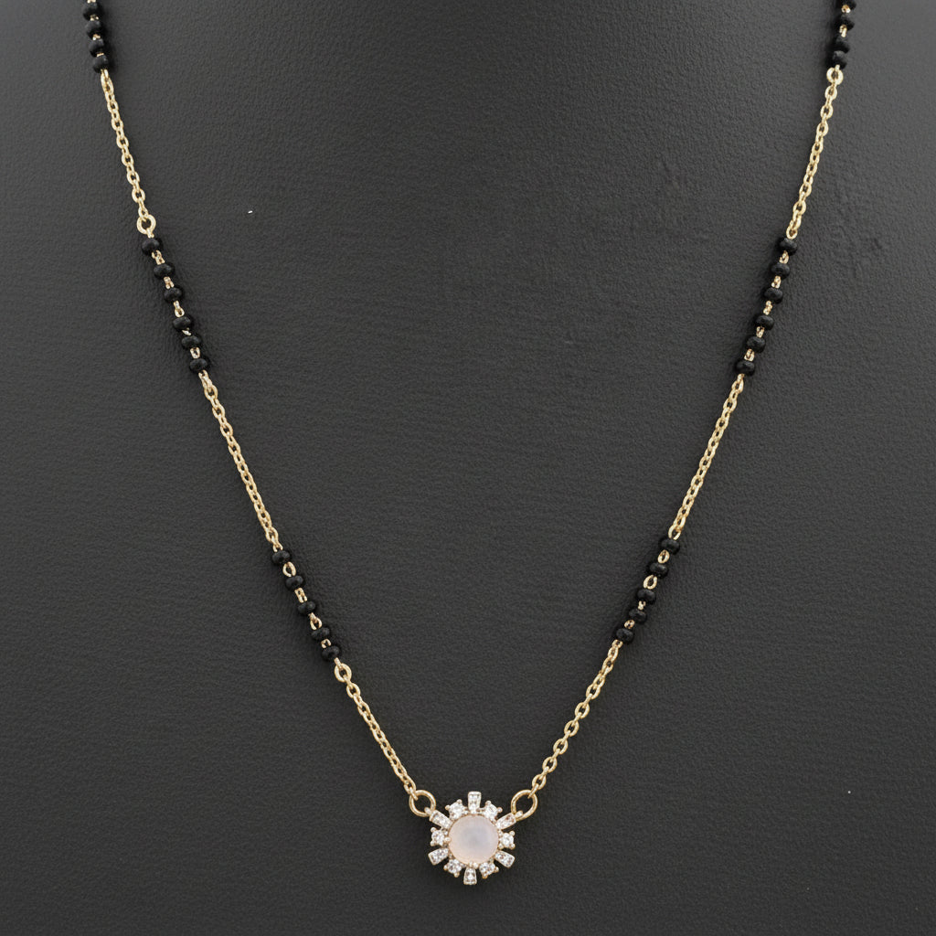 Necklace with black beads and a sunflower pendant on a red fabric background