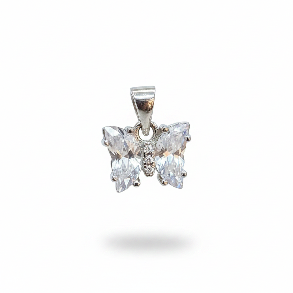 Silver butterfly earrings on a person's hand with a blurred background