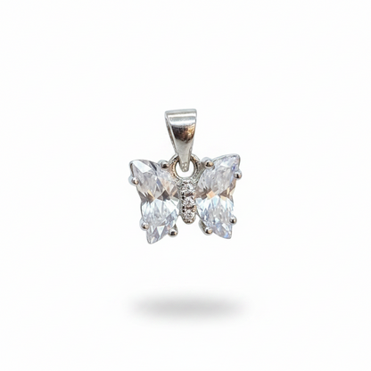 Silver butterfly earrings on a person's hand with a blurred background