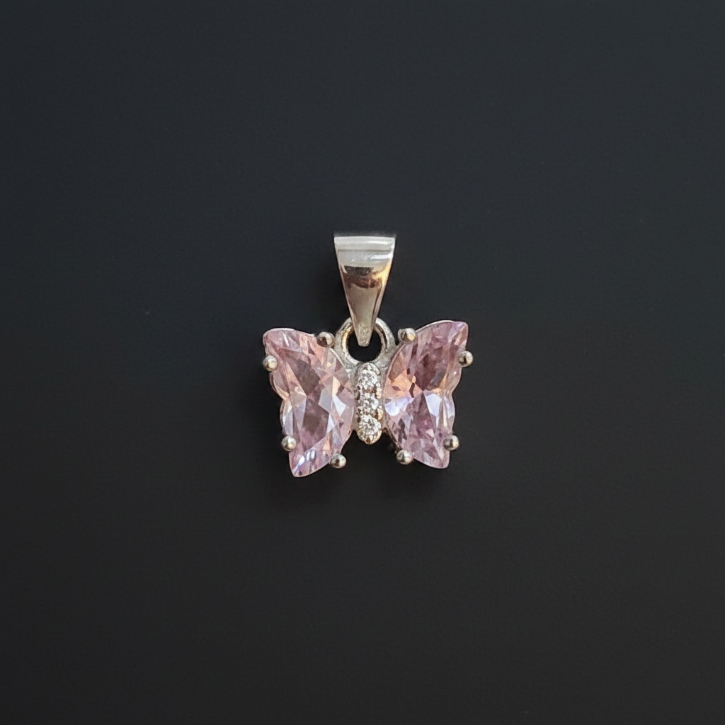 Pink butterfly pendant with 'KLA Silver' tag on a red background