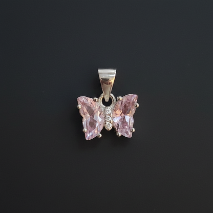 Pink butterfly pendant with 'KLA Silver' tag on a red background