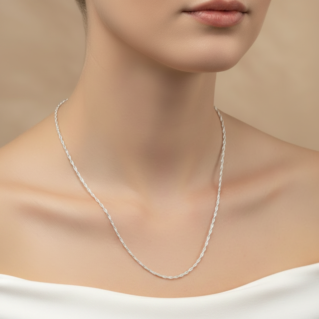 Silver necklace on a model against a beige background