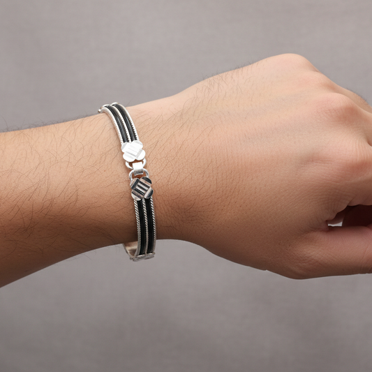 Bracelet on a wrist against a gray background